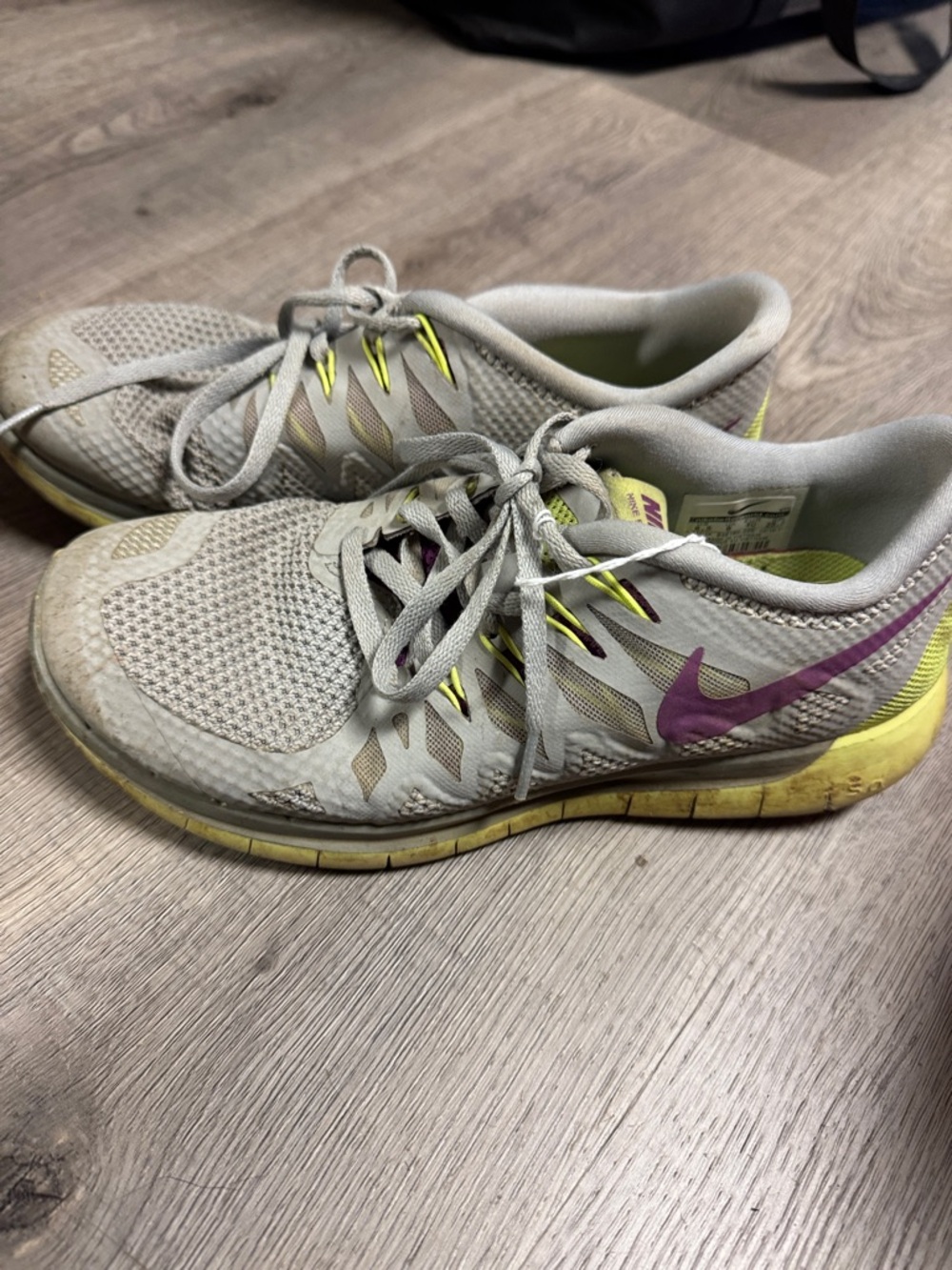 Nike Women's Gray Running Shoes with Yellow and Purple Accents